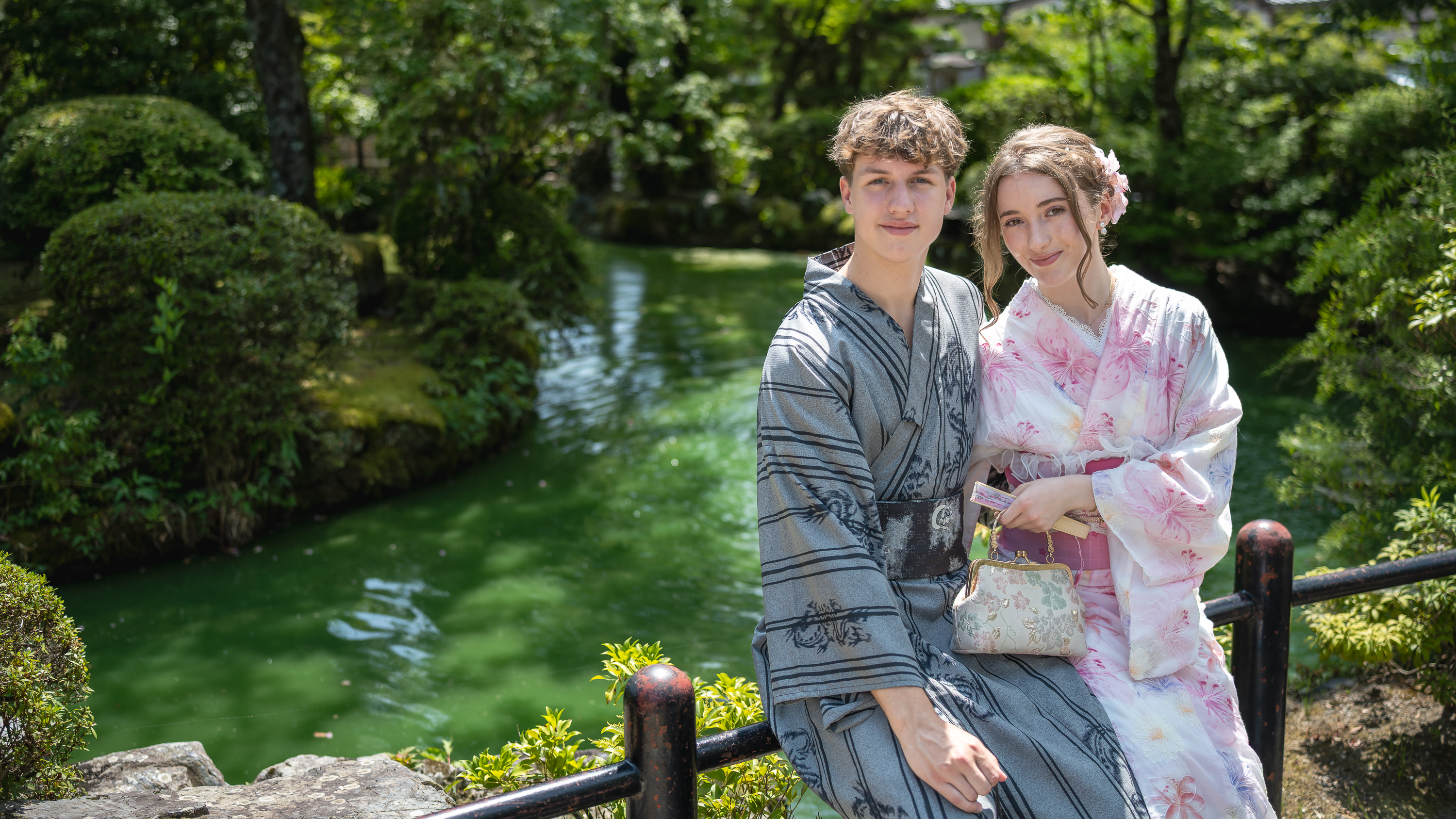 Couple in yukata by a garden pond