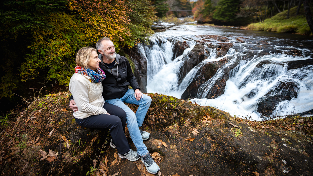 Couple by an autumn waterfall in Nikko